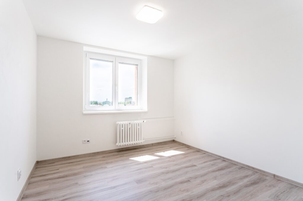empty room with white walls and window in a new building, apartment for rent